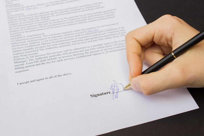 hand signing a paper